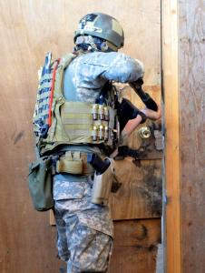 19th SF Group soldier breaching a door with a PGO Mossberg 590